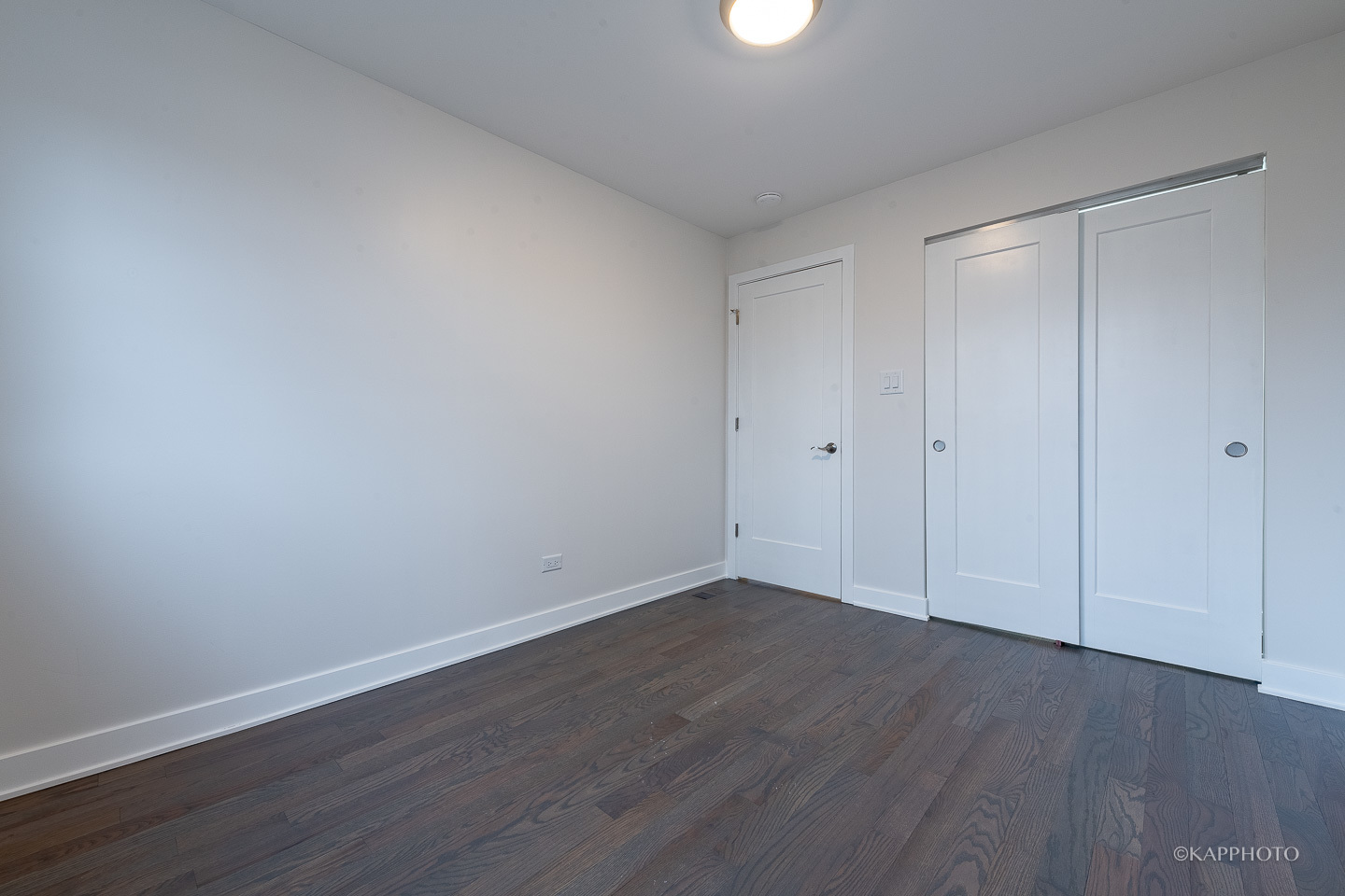 5654 South Princeton Avenue Chicago, IL 60621 - Photo 18 of 29 a view of an empty room with wooden floor