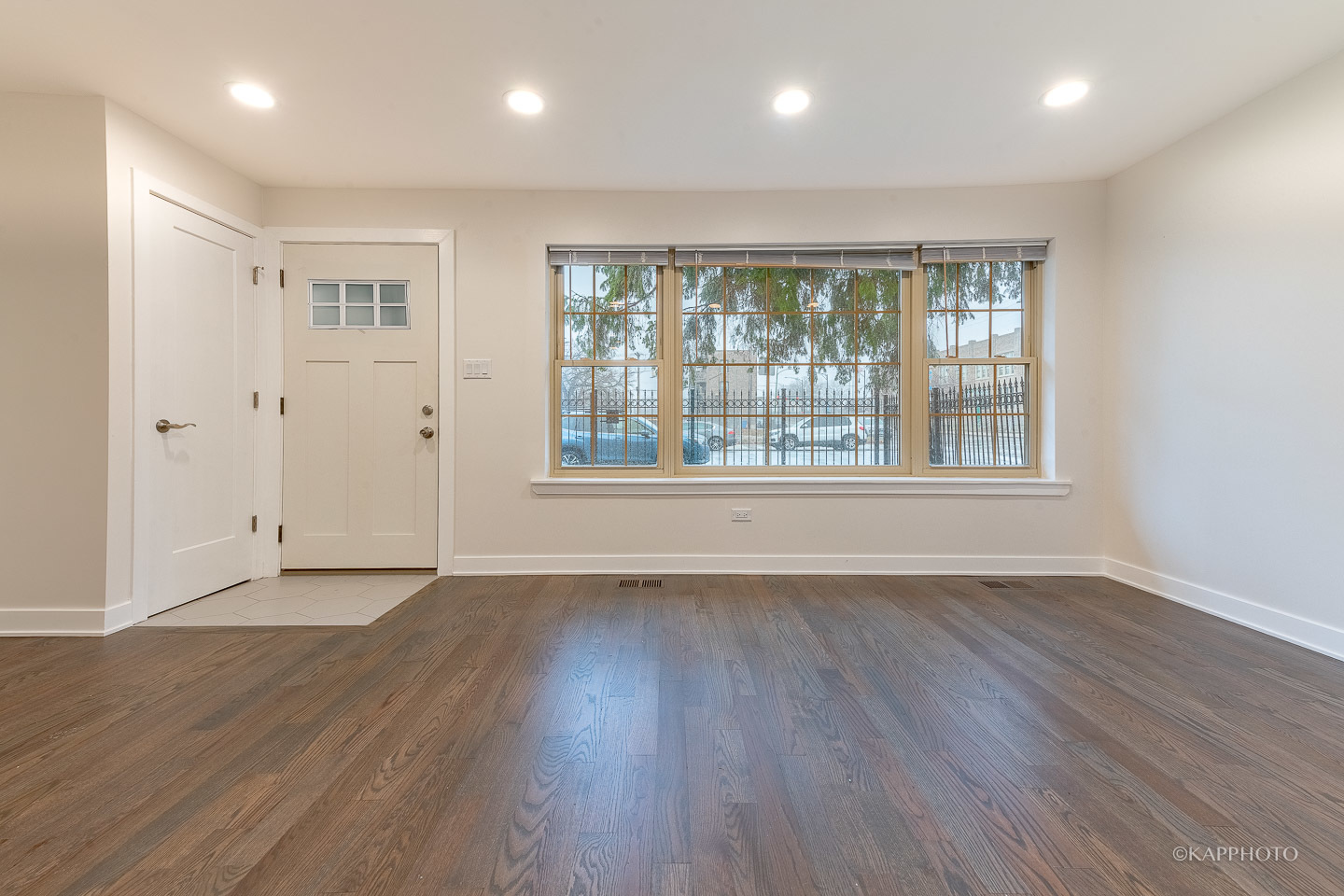 5654 South Princeton Avenue Chicago, IL 60621 - Photo 3 of 29 a view of an empty room with wooden floor and a window