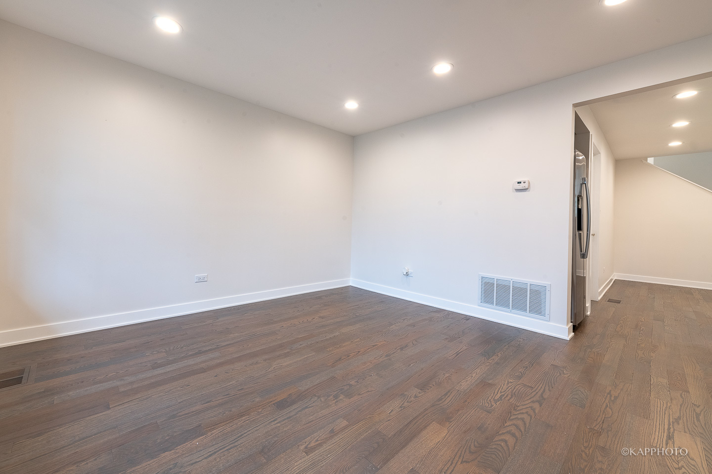 5654 South Princeton Avenue Chicago, IL 60621 - Photo 5 of 29 an empty room with wooden floor and windows