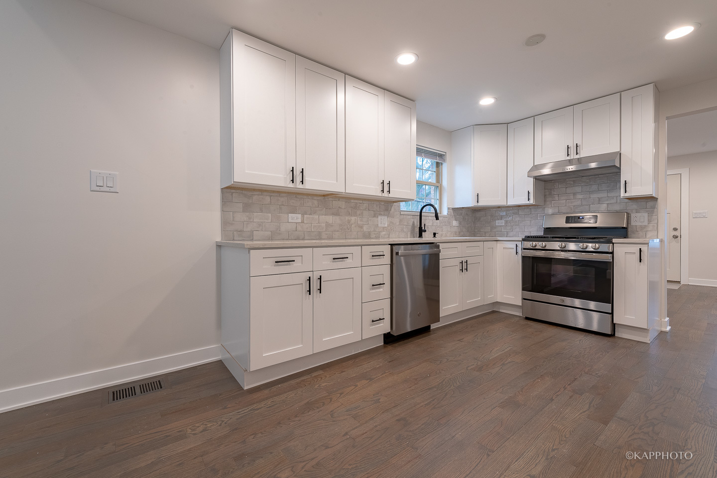 5654 South Princeton Avenue Chicago, IL 60621 - Photo 8 of 29 a kitchen with stainless steel appliances granite countertop a stove a sink and white cabinets