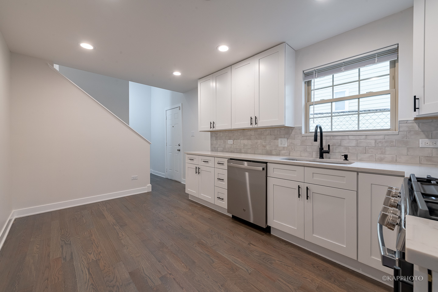 5654 South Princeton Avenue Chicago, IL 60621 - Photo 10 of 29 a view of a kitchen with a sink cabinets and wooden floor