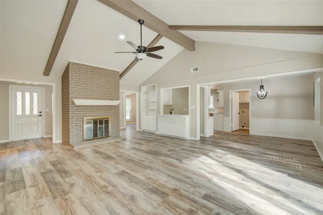 a view of empty room with fireplace and fan