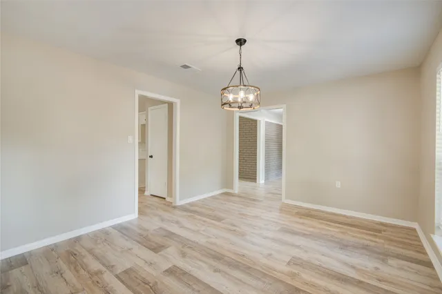 a view of livingroom with chandelier and glass door
