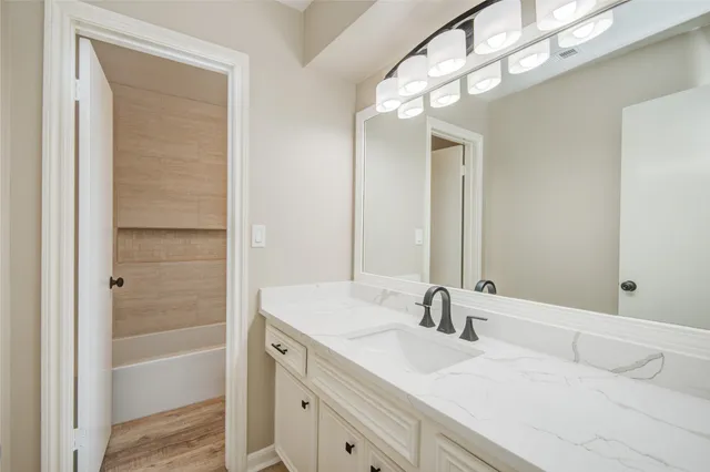 a bathroom with a sink a vanity and a mirror