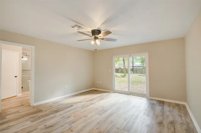 wooden floor in an empty room with a window