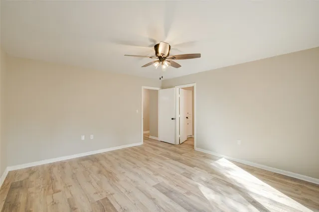 a view of a room with a ceiling fan and a window