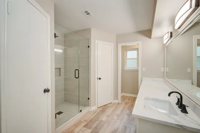 a bathroom with a sink and shower