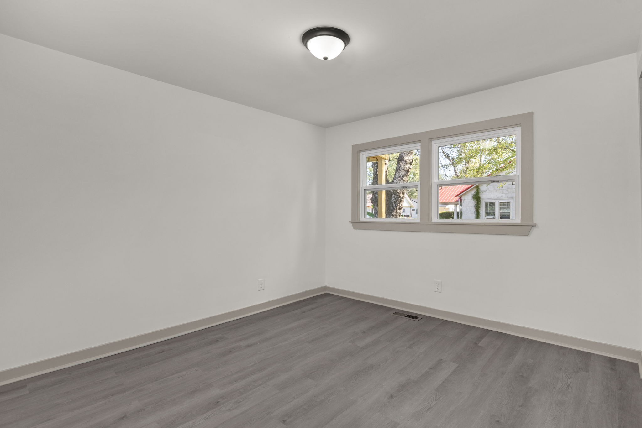503 5th Street Lawrenceburg, TN 38464 - Photo 14 of 19 an empty room with wooden floor and windows