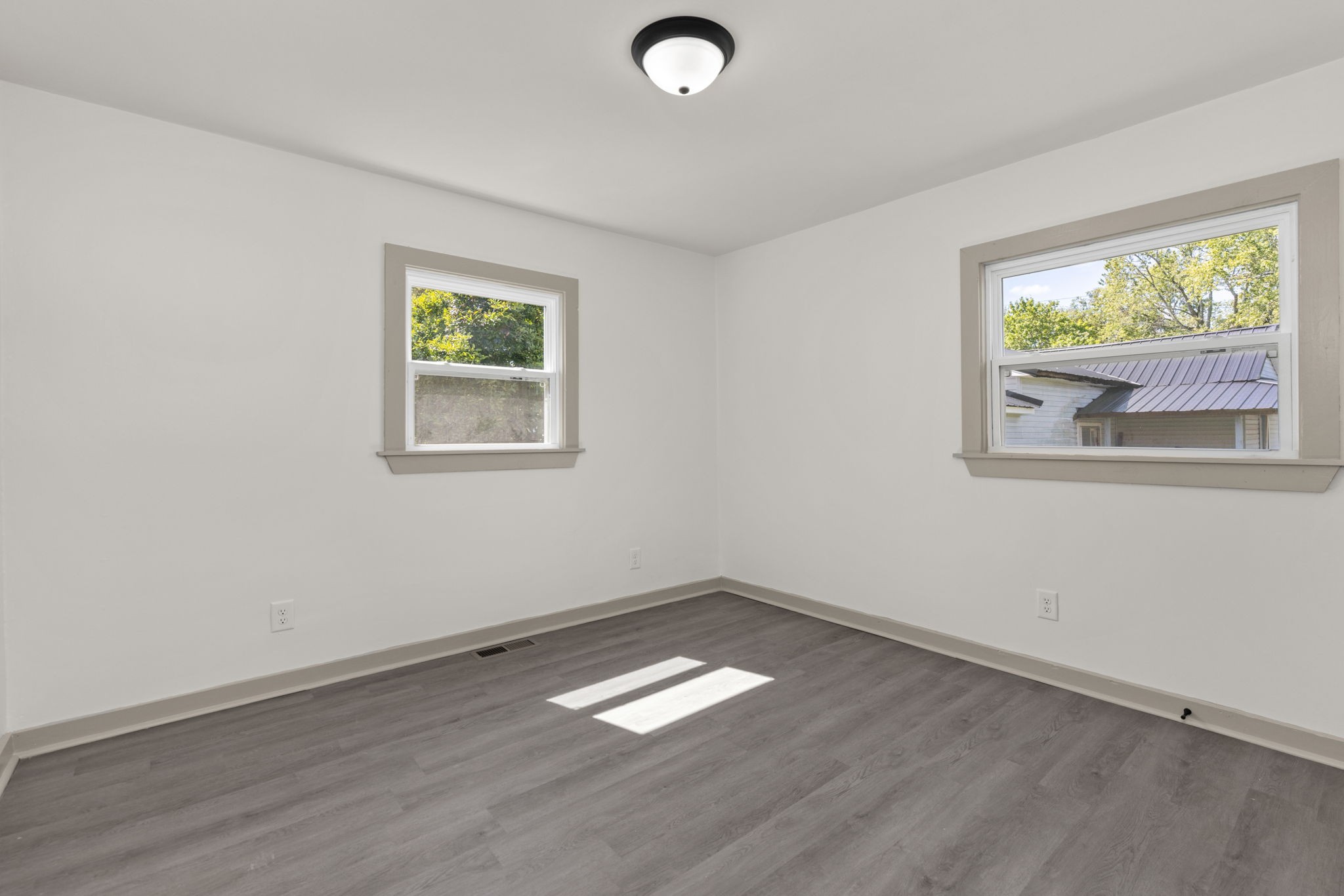 503 5th Street Lawrenceburg, TN 38464 - Photo 18 of 19 an empty room with wooden floor and windows