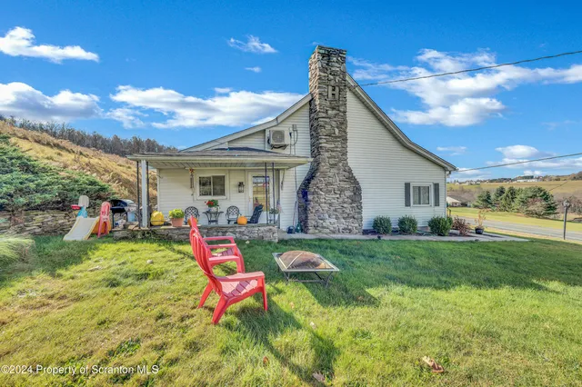 a view of an house with backyard porch and outdoor seating