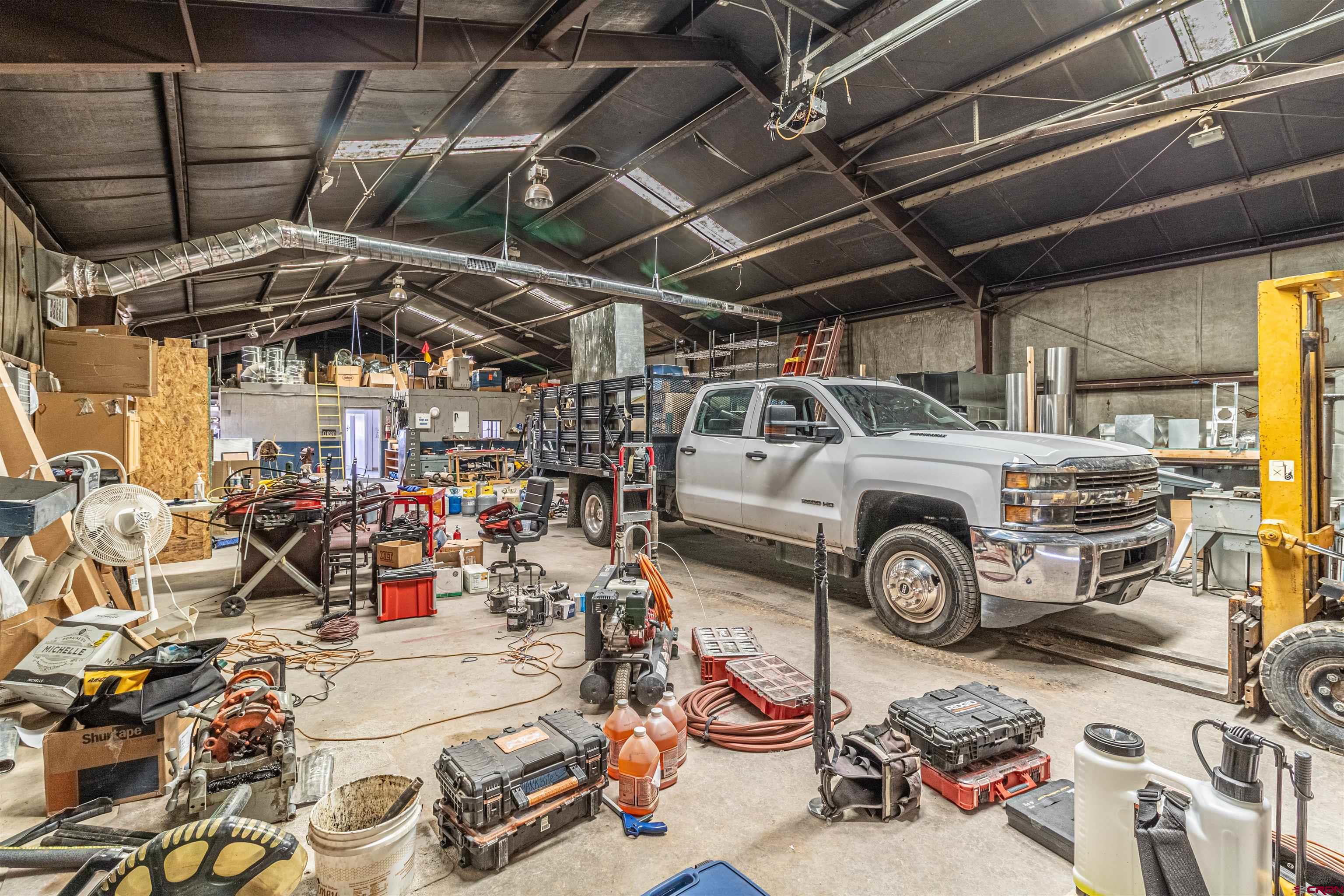 4200 Monroe Road Farmington, NM 87401 - Photo 27 of 45 a car and bike parked in a garage