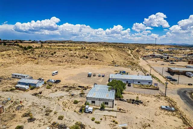 a view of a terrace with lawn chairs