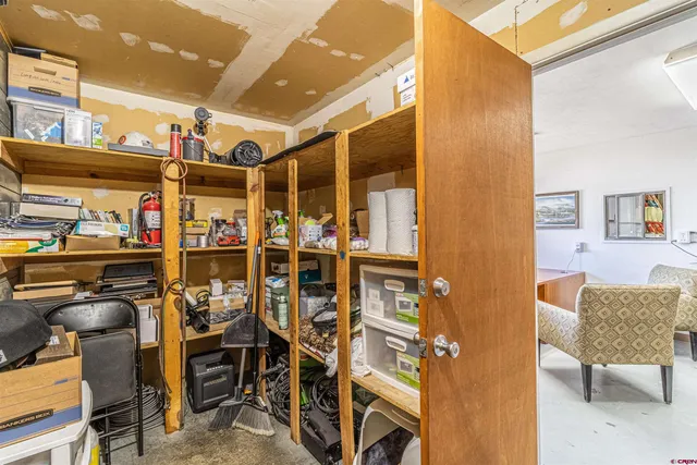 a view of a dining room with furniture and a refrigerator