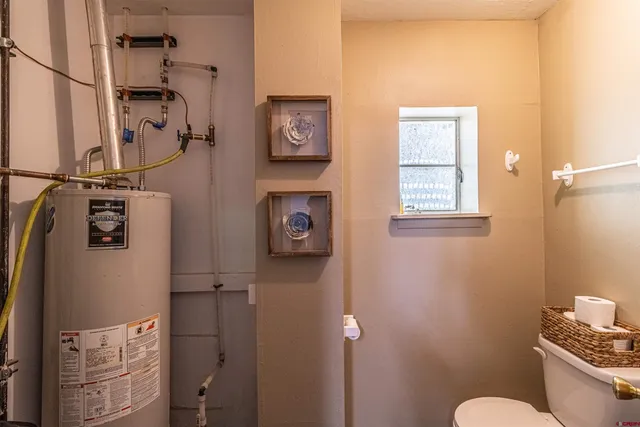 a living room with furniture two window and a table