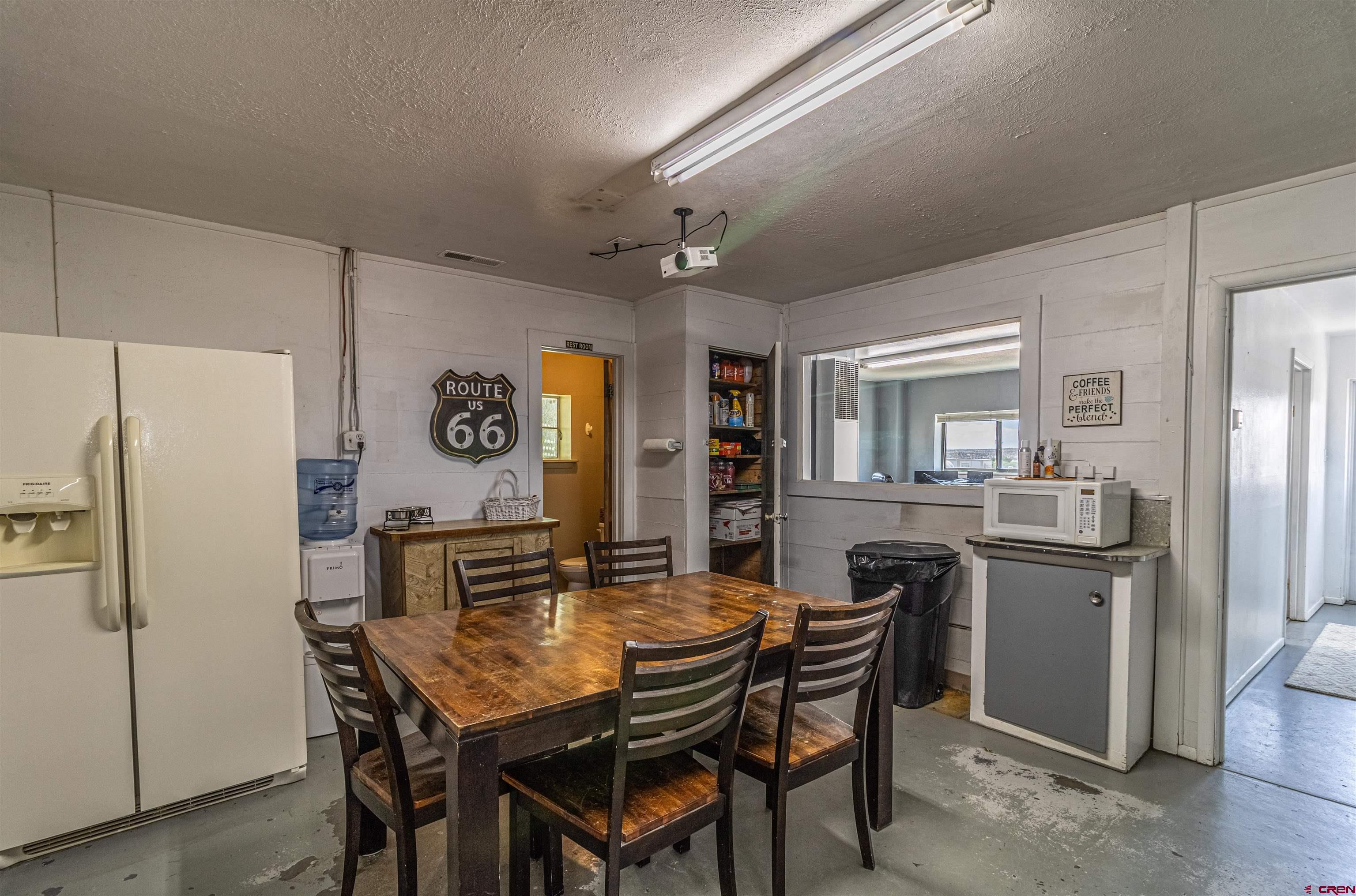 4200 Monroe Road Farmington, NM 87401 - Photo 39 of 45 a view of a dining room with furniture and a refrigerator
