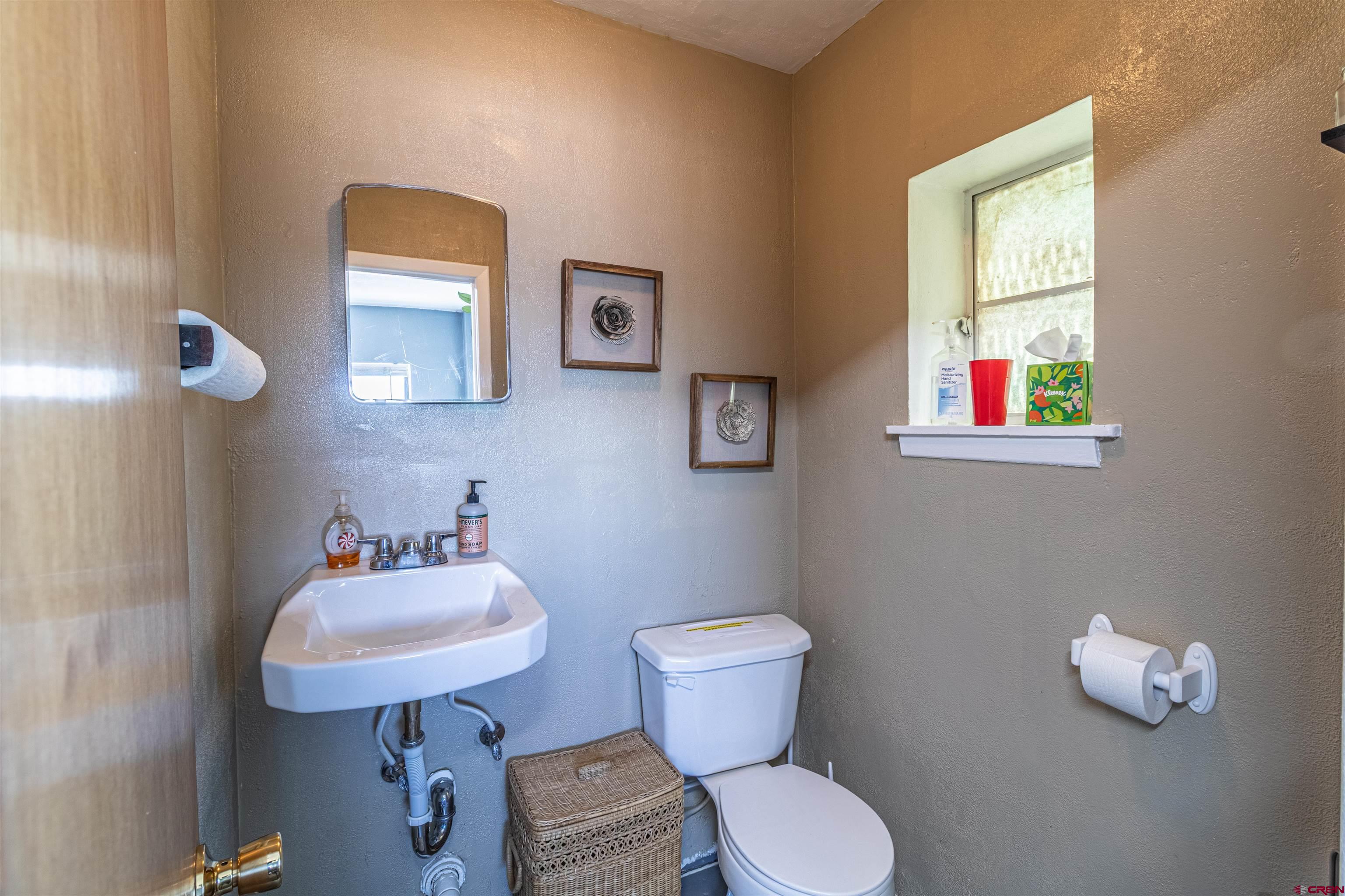 4200 Monroe Road Farmington, NM 87401 - Photo 41 of 45 a bathroom with a toilet sink and mirror