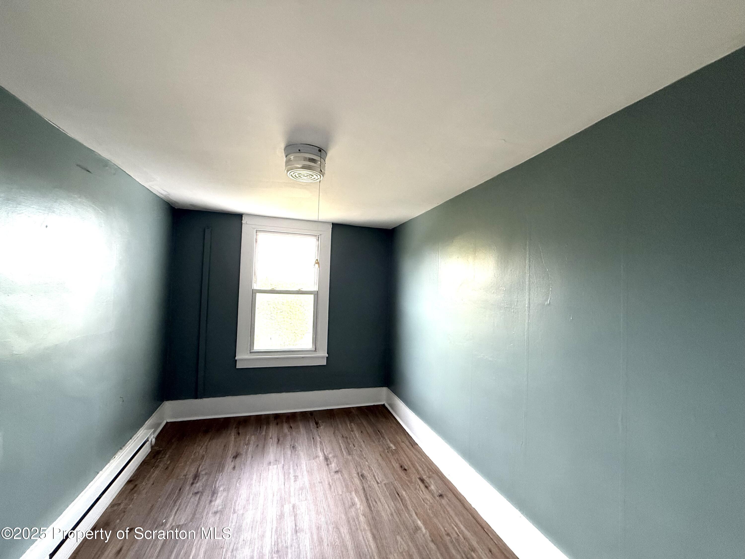 755 Main Street Sugar Notch, PA 18706 - Photo 12 of 13 an empty room with wooden floor and windows