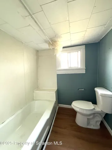 a bathroom with a bathtub and toilet