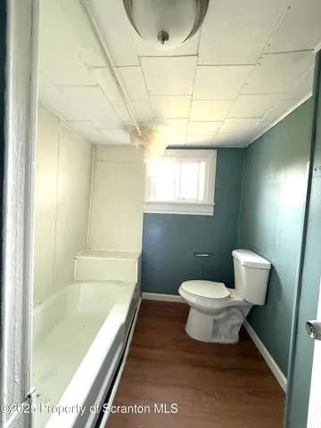 a bathroom with a toilet a sink and bathtub