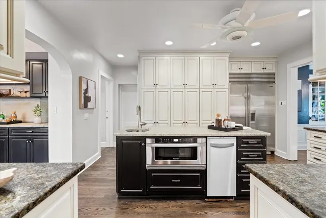 a kitchen with stainless steel appliances granite countertop a sink stove and refrigerator
