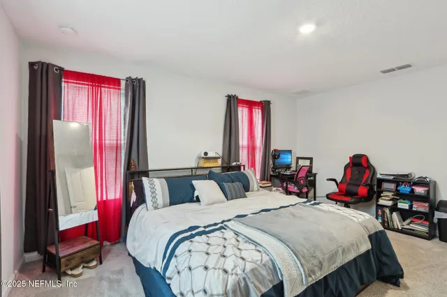 a bedroom with bed and a mirror