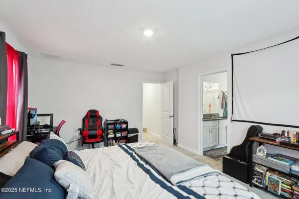 a bed room with furniture and a flat tv screen