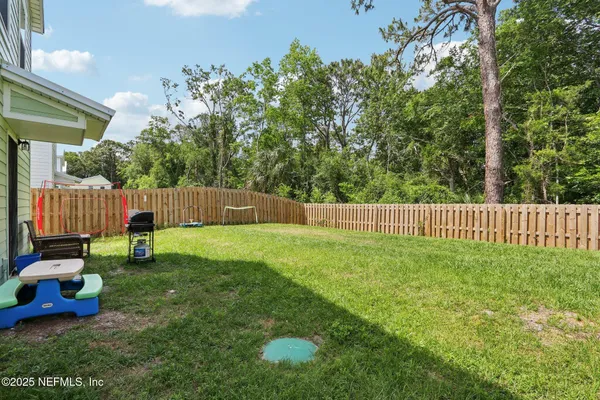a view of a backyard with a small cabin and a chair