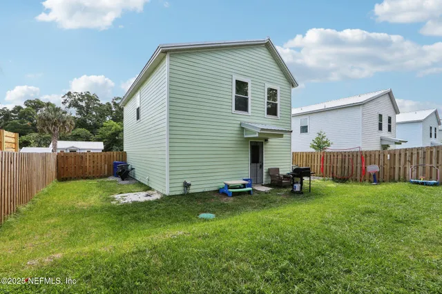 a view of a house with a yard and deck