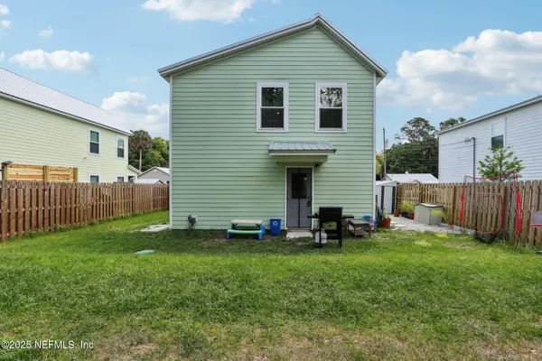 a front view of house with yard and deck