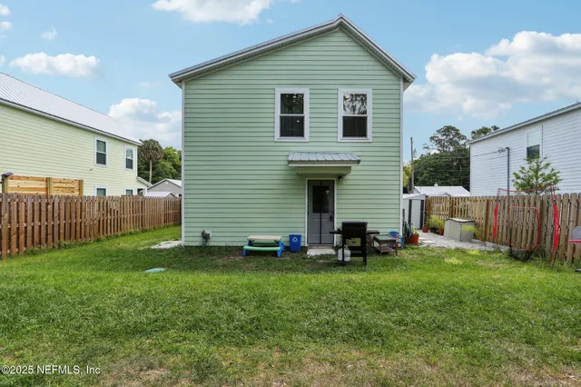 a front view of house with yard and deck