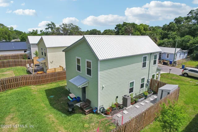 a view of a house with a backyard and a garden