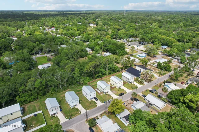 a view of a city with lush green forest