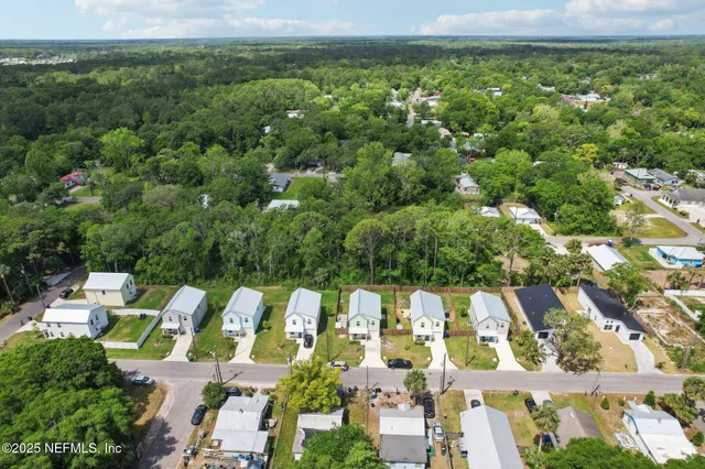 an aerial view of residential houses with outdoor space