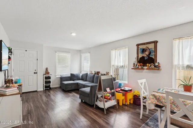 a living room with furniture and wooden floor