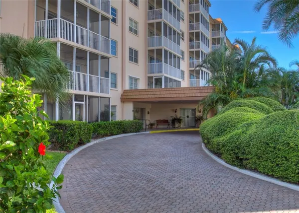 a view of a building with a yard and potted plants