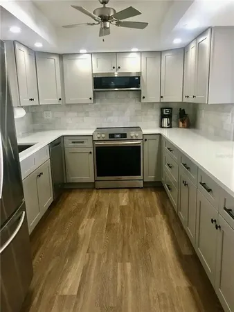 a kitchen with stainless steel appliances granite countertop a sink and cabinets