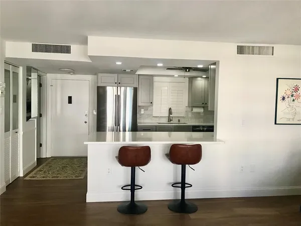 a view of living room with furniture and a potted plant