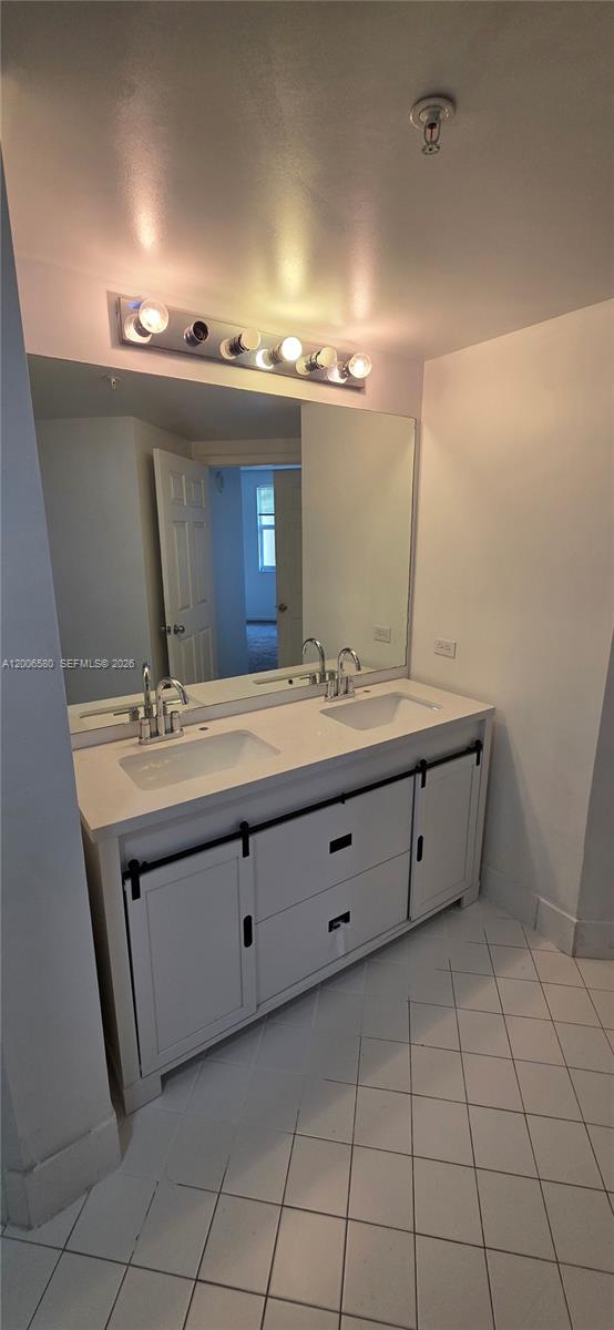 17150 North Bay Road, Unit 2602 Sunny Isles Beach, FL 33160 - Photo 24 of 27 a bathroom with a sink double vanity and a mirror