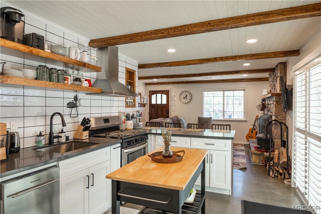 682 Maple Lane Sugarloaf, CA 92386 - Photo 11 of 20 a kitchen with a sink a stove and chairs