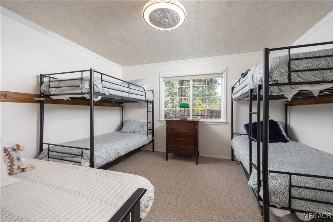 682 Maple Lane Sugarloaf, CA 92386 - Photo 15 of 20 a bedroom with a bed and a chandelier