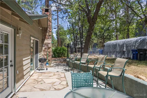 a view of backyard of house with outdoor seating