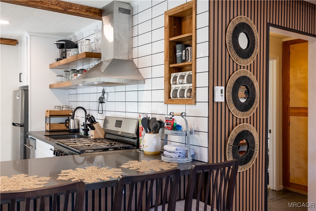 682 Maple Lane Sugarloaf, CA 92386 - Photo 8 of 20 a kitchen with a stove and a wooden cabinets