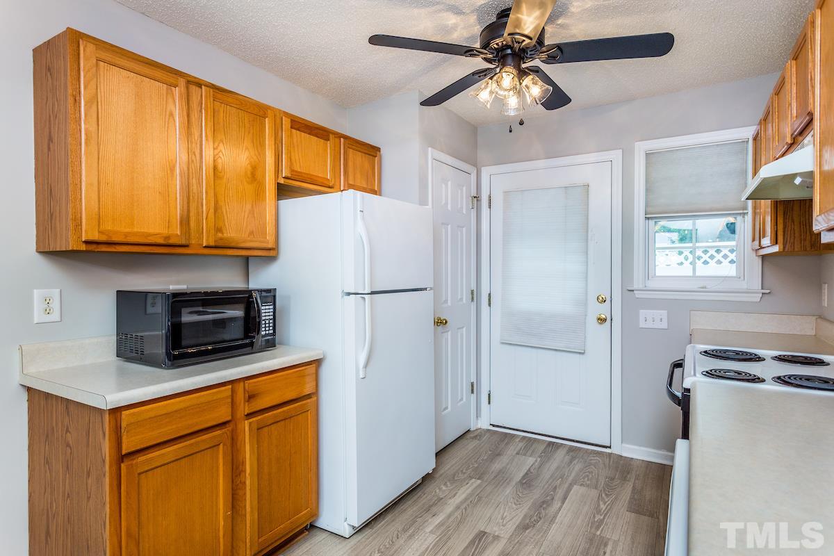 3752 Votive Lane Raleigh, NC 27604 - Photo 11 of 22 a kitchen with stainless steel appliances granite countertop a refrigerator a stove a sink dishwasher and a microwave oven