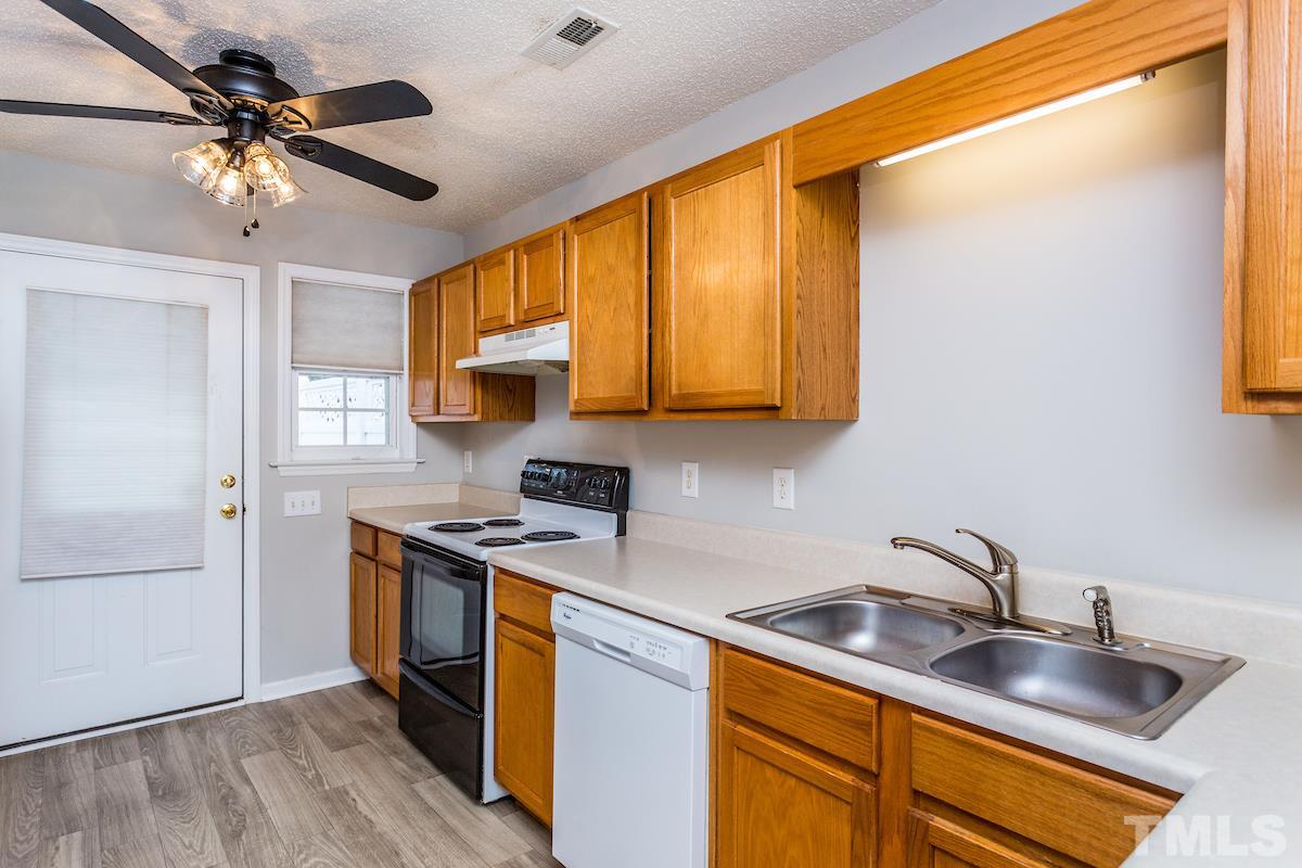 3752 Votive Lane Raleigh, NC 27604 - Photo 12 of 22 a kitchen with stainless steel appliances granite countertop a sink a stove and a refrigerator