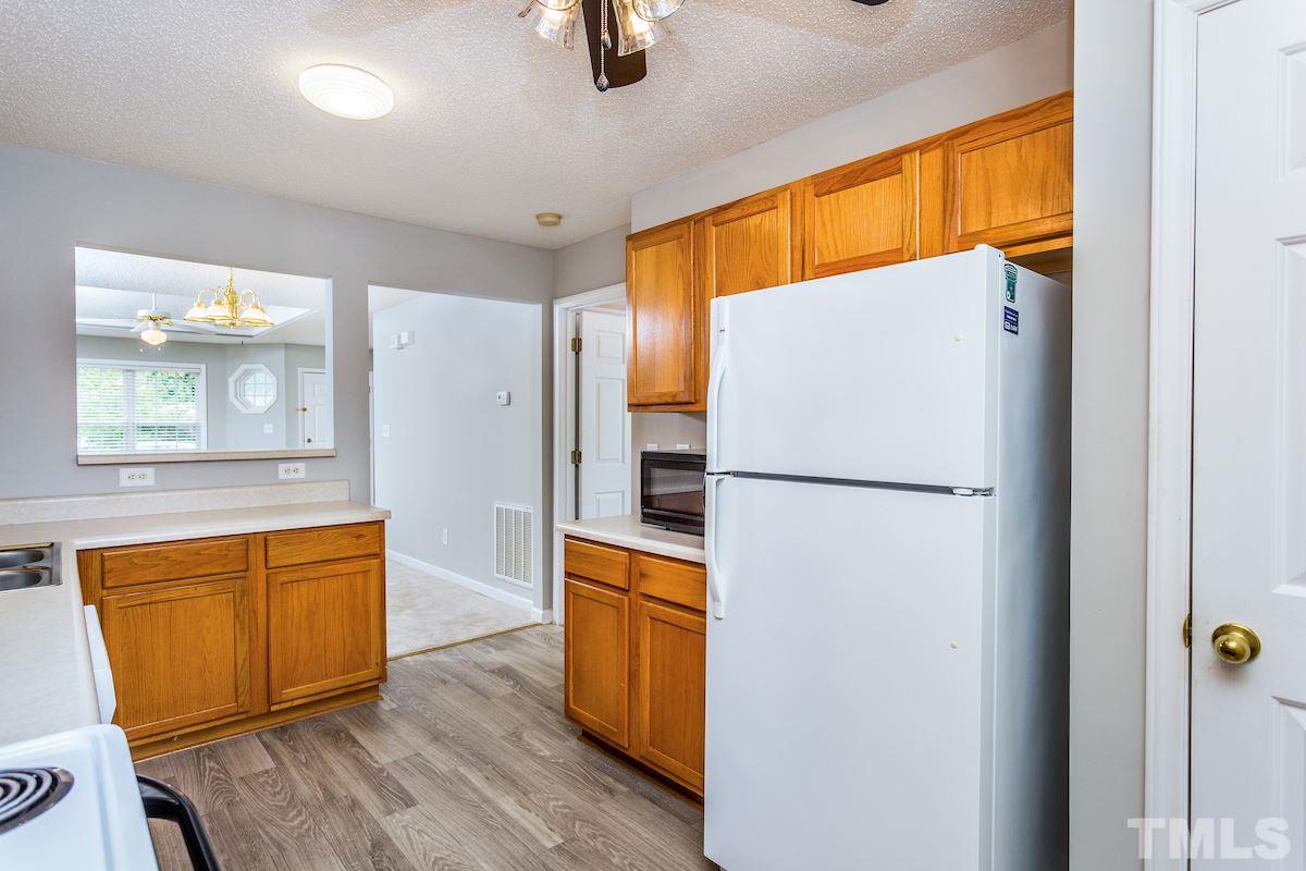 3752 Votive Lane Raleigh, NC 27604 - Photo 10 of 22 a white refrigerator freezer sitting inside of a kitchen