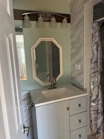 a bathroom with a shower and a sink