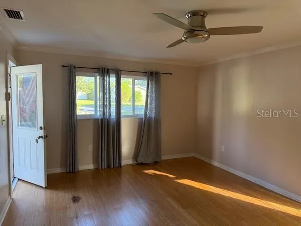 wooden floor in an empty room with a window