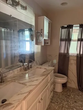 a bathroom with a sink toilet and shower