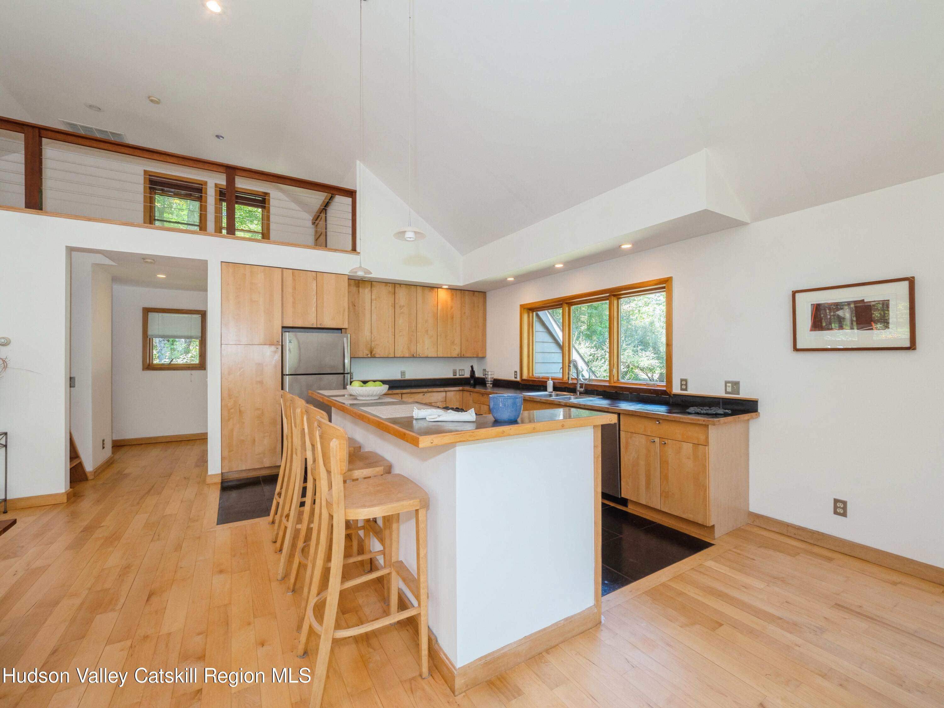 7 Clovewood Road High Falls, NY 12440 - Photo 13 of 41 a kitchen with stainless steel appliances granite countertop a stove top oven a sink dishwasher and a refrigerator with wooden floor