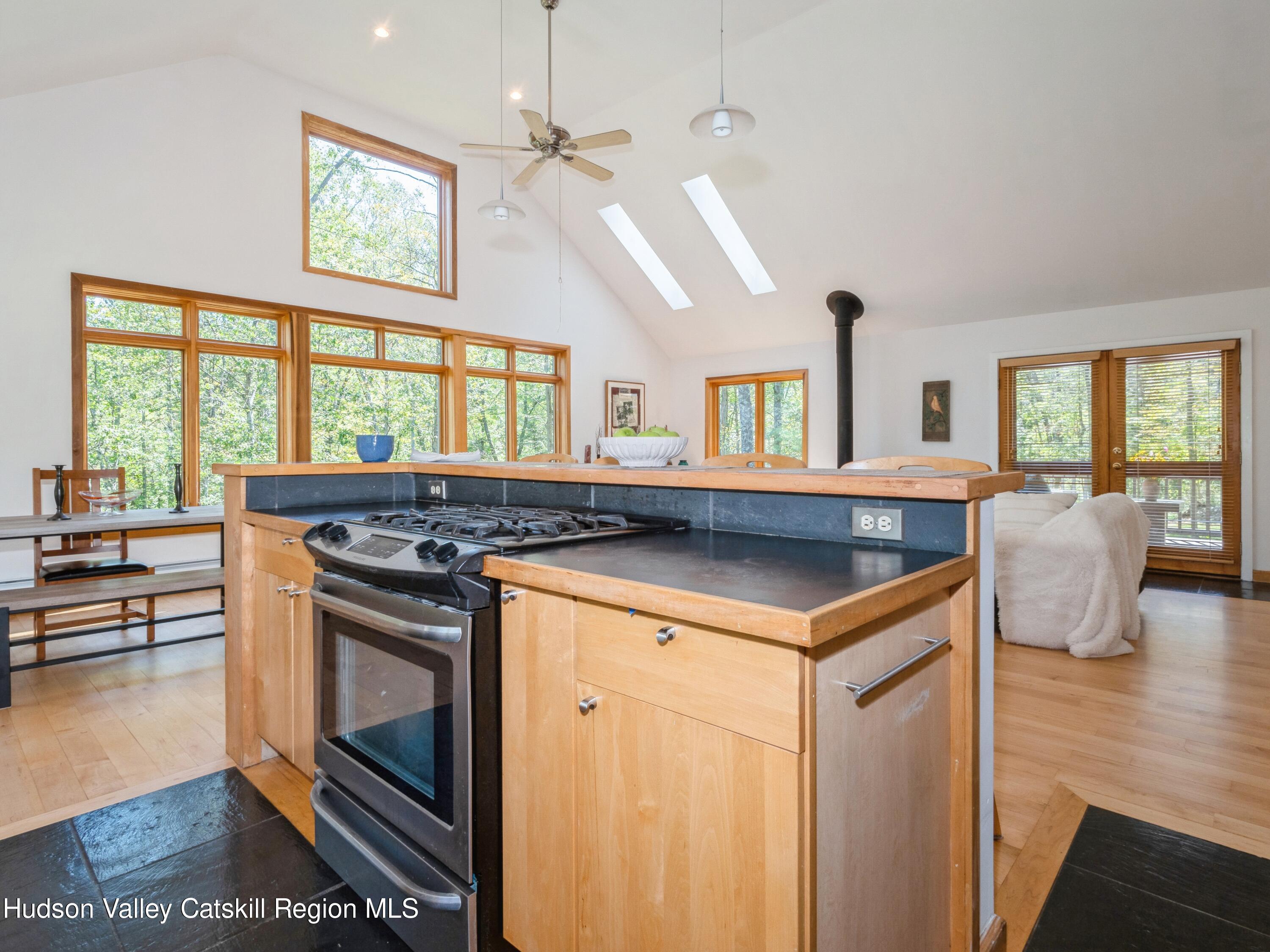 7 Clovewood Road High Falls, NY 12440 - Photo 14 of 41 a kitchen with a stove a sink a dining table and chairs